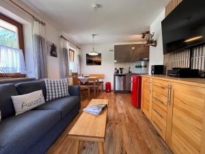 a living room with a couch and a kitchen at Ferienwohnung Sonnenglück in Schönau am Königssee +18 photos