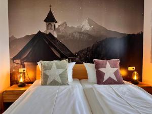 a bedroom with a large bed with a church mural at Ferienwohnung Sonnenglück in Schönau am Königssee