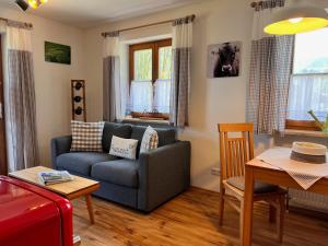 a living room with a couch and a table at Ferienwohnung Sonnenglück in Schönau am Königssee