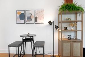 a dining room with a table and two stools at Updated 1 BR Home - Steps to 7th Ave in Tampa