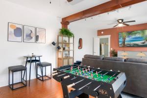 a living room with a large foosball table at Updated 1 BR Home - Steps to 7th Ave in Tampa