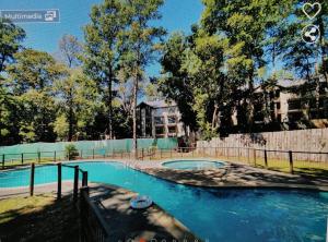 a swimming pool in front of a building at Departamento en Pucón in Pucón