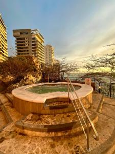a circular concrete island in the middle of a city at Maravillosa Vista al Mar en El Peñon del Rodadero in Gaira