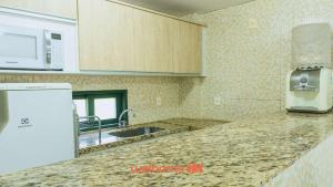 a kitchen with a sink and a counter top at Refugio com Lazer Completo em Gravata in Gravatá