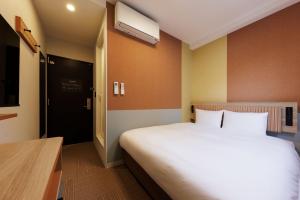 Postel nebo postele na pokoji v ubytování CVS Bay Hotel
