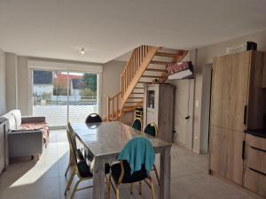 a kitchen and dining room with a table and chairs at Maison de vacances à Fort Mahon Plage, Baie d'Authie - FR-1-482-154 in Fort-Mahon-Plage