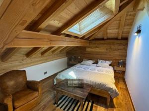 a bedroom with a bed and a chair at Duplex Prestige 9 Pers - Terrasse Sud - Face aux Pistes - Animaux Acceptés - Parking - FR-1-445-220 in Montgenèvre