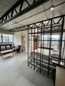 ein Zimmer mit zwei Etagenbetten und einer Couch in der Unterkunft Acogedor apartamento en Santa Rosa de Cabal in Santa Rosa de Cabal