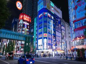 a busy city street with tall buildings at night at APA Hotel Akihabara Ekimae in Tokyo