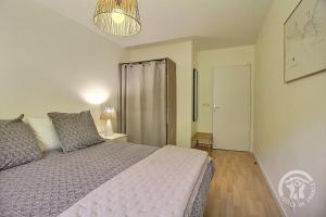 a bedroom with a bed and a sliding door at Les bains in Pléneuf-Val-André