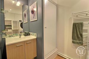 a bathroom with a sink and a mirror and a shower at Les bains in Pléneuf-Val-André +19 photos