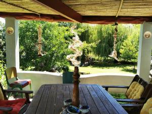 a wooden table on a porch with smoke coming at Karstaway Haven in Takaka