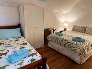 a bedroom with two beds with towels on it at Cottage Bliss on Moonta Main St in Moonta