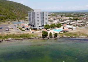 an aerial view of a hotel and the water at 2 Bedrooms 2 Bathrooms Luxury Gated Condo with Beach and Breathtaking Views of Kingston Harbour and 2 swimming Pools in Portmore