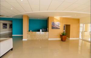 an office lobby with a green wall and a desk at 2 Bedrooms 2 Bathrooms Luxury Gated Condo with Beach and Breathtaking Views of Kingston Harbour and 2 swimming Pools in Portmore +71 photos