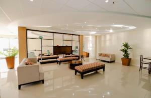 a living room with couches and chairs and a tv at 2 Bedrooms 2 Bathrooms Luxury Gated Condo with Beach and Breathtaking Views of Kingston Harbour and 2 swimming Pools in Portmore