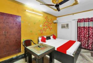 a bedroom with a bed and a table at PREMIUM THE BEST HOTEL Near Railway Station - Wifi and Fully Air Conditioning Room - Prime Location - Room Service and Excellent Customer Service Awarded in Bādshāhnagar