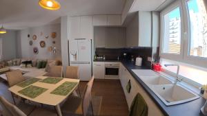 a kitchen and dining room with a table and a sink at Trip'n'Hostel Chill Zone in Tirana
