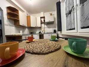 a wooden table with plates and cups on top of it at Frania in Zgórsko