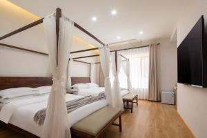 Voodi või voodid majutusasutuse Dunhuang County Posthouse toas