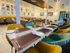 a restaurant with a long table and chairs at Radiant Pearl in Etāwah