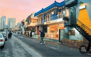 a man standing on the street in front of a building at Atelier PADO 102 in Busan