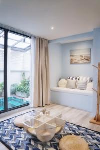 a living room with a couch and a table at Somewhere house in Bangkok