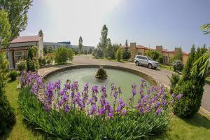 a garden with purple flowers in the middle of a road at Arena Hotel Gazakh in Qazax