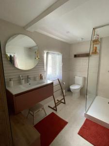a bathroom with a sink and a toilet and a mirror at Maison Familiale de Centre-Ville in Dives-sur-Mer +21 photos