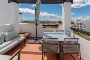 a living room with a couch and a table and chairs at La Terraza Azul - las terrazas de la torre - regio murcia in Torre-Pacheco