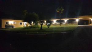 a house lit up at night with lights at L'Hacienda in Manciet