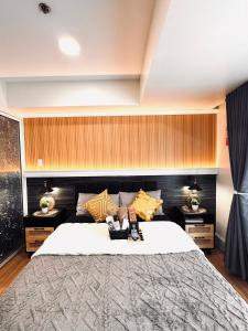 a bedroom with a large bed and two tables at Condo Azure Urban Resort Paranaque in Manila