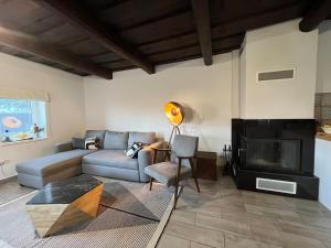 a living room with a couch and a fireplace at Drevenica U Feleja in Pohorelá