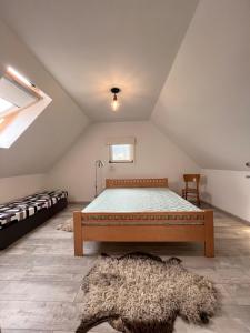 a bedroom with a bed in a attic at Drevenica U Feleja in Pohorelá