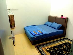Ένα ή περισσότερα κρεβάτια σε δωμάτιο στο Homestay Nafisah Jasin Height - 3 Bedrooms