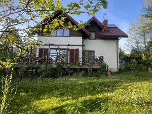 a house with a large yard in front of it at Leśna 6 - House with a garden in Bolechowice