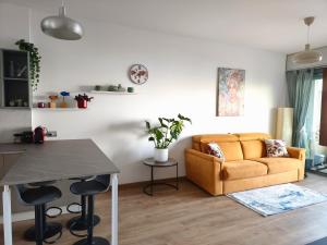 a living room with a couch and a table at BLOOM al Mare in Ventimiglia