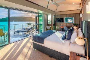 a bedroom with a bed and a view of the water at Yacht Club Villas on Hamilton Island by HIHA in Hamilton Island