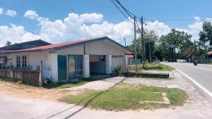 a small building on the side of a road at Simple2 Guesthouse in Pantai Cenang