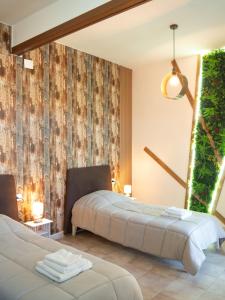 a bedroom with two beds and a wall mural at Affittacamere DaME in Foligno