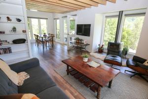 a living room with a couch and a table at Bonnie's Cottage - Peaceful retreat in Wandiligong