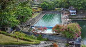 a large swimming pool in the middle of a river at Mataram Square Hotel in Gili Trawangan