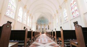 an empty church with a row of chairs and a aisle at V3 Hotel in Surabaya +21 photos