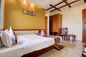 a bedroom with a large bed in a room at FabHotel Khushi Regent - Near DB Mall in Bhopal