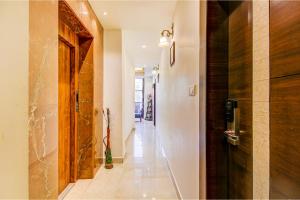 a hallway with a door and a hallway with at FabHotel Khushi Regent - Near DB Mall in Bhopal +19 photos