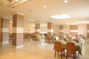 a restaurant with tables and chairs in a room at Arena Hotel Dashkasan in Xoşbulaq