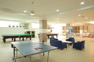 a room with a pool table and ping pong tables at Arena Hotel Dashkasan in Xoşbulaq