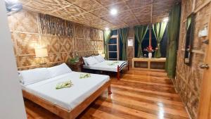 a room with two beds and a couch in it at Venida Farm in Sampong