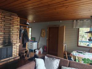 a living room with a couch and a window at Ahlaistentupa in Pori