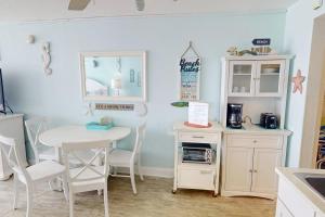 a kitchen with a table and a table and chairs at 318 - Island Inn in St. Pete Beach